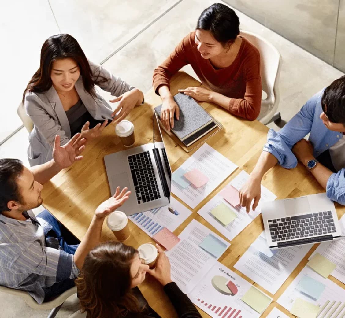Team analyzing customer data and business insights around a table