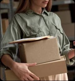 Woman carrying cardboard boxes for online store packaging