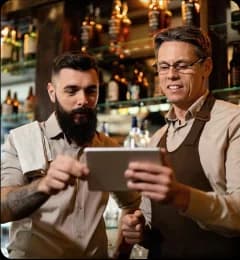 Bartenders reviewing orders on tablet